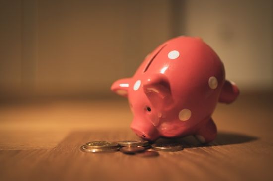 pink piggy bank with coins